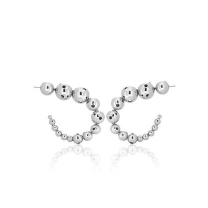 Pair of medium silver earrings featuring a curved design made of graduated metallic spheres.