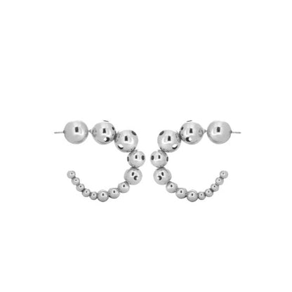 Pair of small silver earrings featuring a curved design made of graduated metallic spheres.